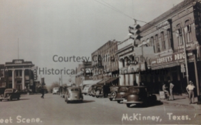 Photo of the east side of the square. Shaine's Corner is at the far end of the block, next to the First National Bank of McKinney. Coffey's Drugs is on the near end.